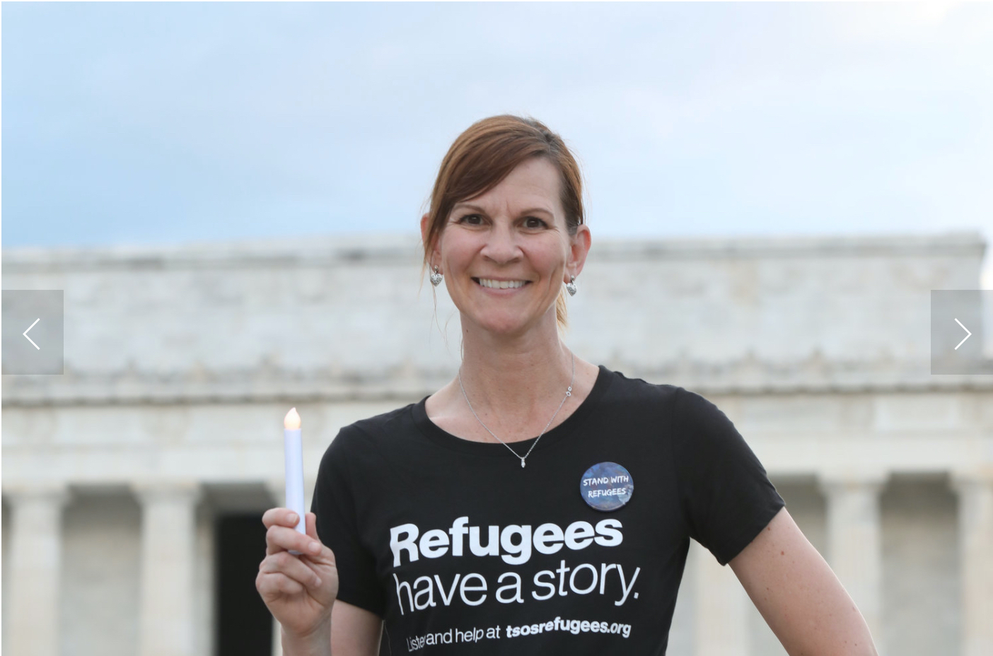 Brandi Kilmer is dressed in a black "Refugees have a story" Tshirt.